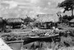 Seminole_dugout_canoe_by_a_village.jpg